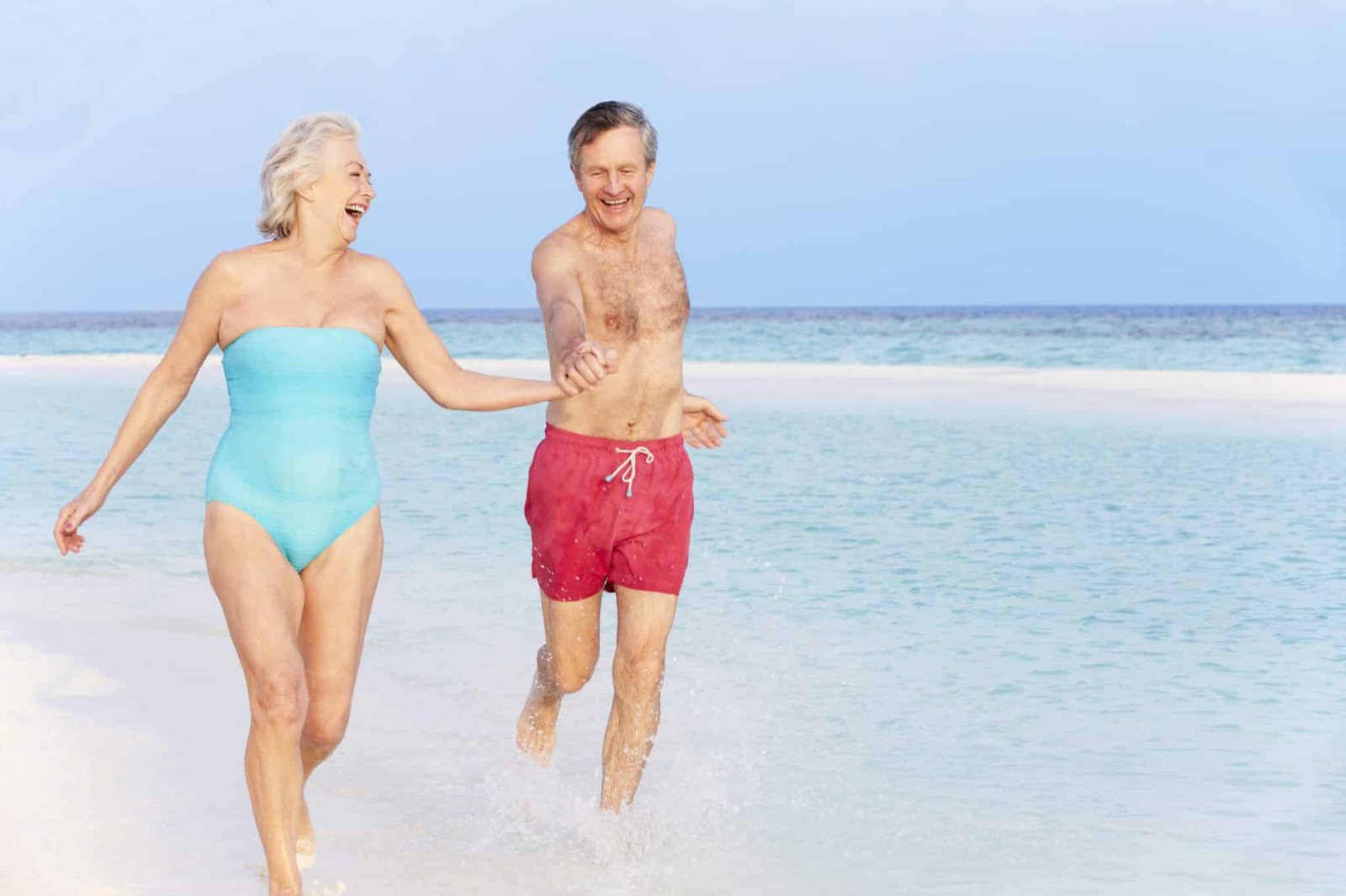 Senior Couple Splashing In Beautiful Tropical Sea
