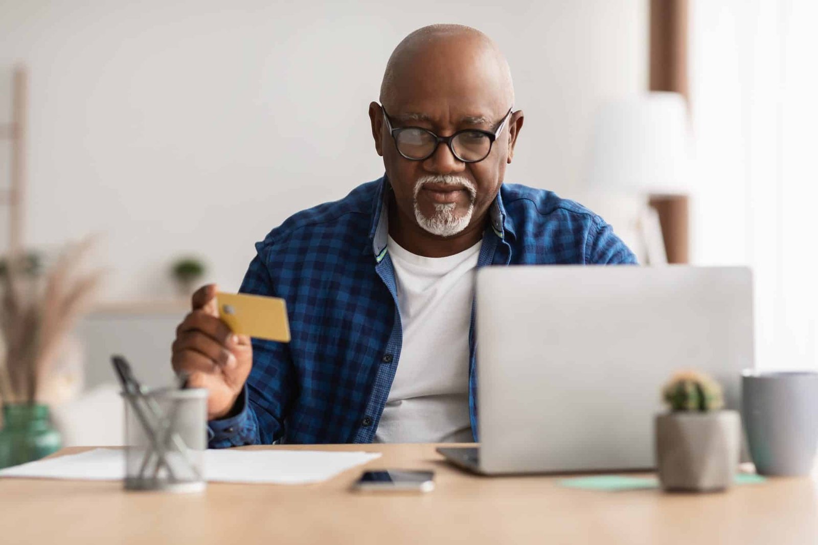 Senior Black Male Shopping With Credit Card Using Laptop Indoor