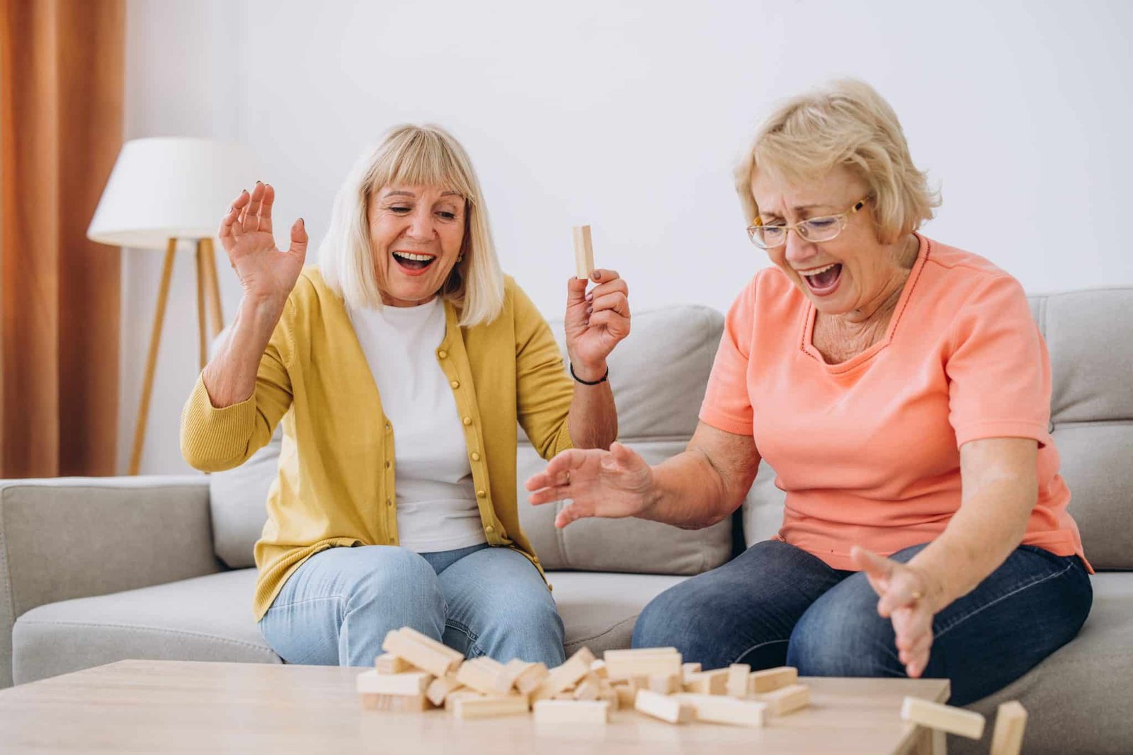 Two senior women female woman friends or family sisters play lei